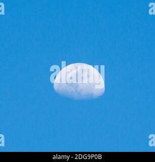 Three Quarter gibbous moon rises in a blue sky above the Atacama Desert, chile Stock Photo