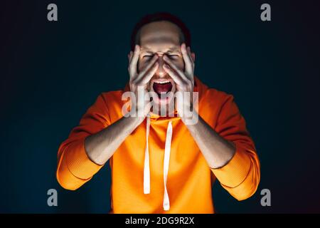 Hiding face. Portrait of crazy scared and shocked caucasian man ...