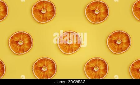 Dried orange on a yellow background. Dried orange slices in rows Stock Photo