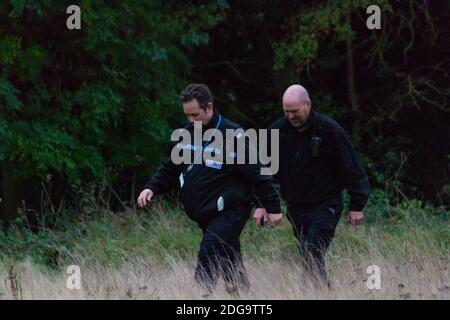 Specialist officers from West Midlands Police wading through the overgrowth on Newbold Comyn, where a woman's body was found Thursday 29th October. Anthony Russell, 38, was later charged with murder along with two others who were killed in Coventry earlier in the year. Stock Photo