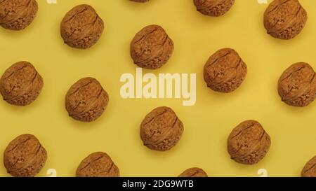 Walnuts lie in rows on yellow cardboard. Top view. Stock Photo