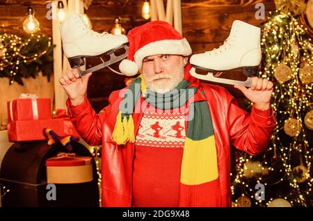 bearded man ready for sport. merry christmas. happy new 2020 year. xmas gifts and presents. winter season activity. holiday time spending outdoor. santa man figure skating. Stock Photo