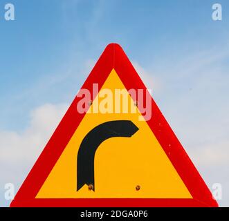 Road signal attention of the curve in the sky Stock Photo