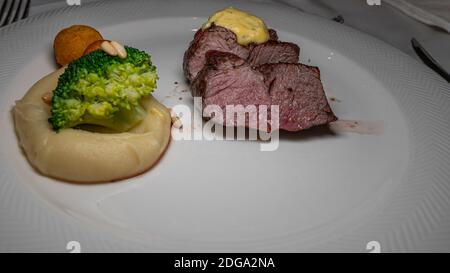 Grilled steak with vegetables on white plate. Stock Photo
