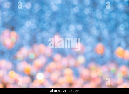 Blurred abstract bokeh background of lighting decoration from ceiling in theme of New Year celebration, lighting colour of blue, yellow, pink and oran Stock Photo