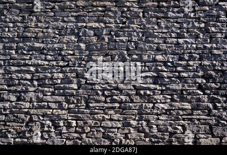 stone wall surface, Black brick wall texture, brick surface for background. Vintage wallpaper. Stock Photo