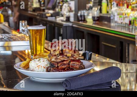 Grilled Pork Baby Ribs With Barbecue Sauce On A White Plate On A Wooden Table Stock Photo