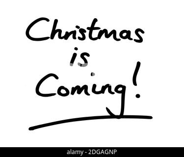 Christmas is Coming! handwritten on a white background. Stock Photo