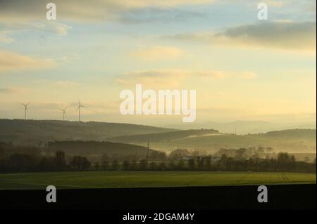 Fulda, Germany. 08th Dec, 2020. View from the Fulda district Dietershan at sunrise to the heights of the 'Naturpark Hessische Rhön' with windmills (l). Credit: Andreas Arnold/dpa/Alamy Live News Stock Photo