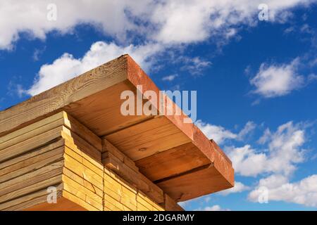 Stack of dimensional lumber for home construction with partly cloudy sky. Stock Photo