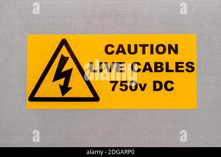Caution Live Cables 750V DC label on a grey background Stock Photo
