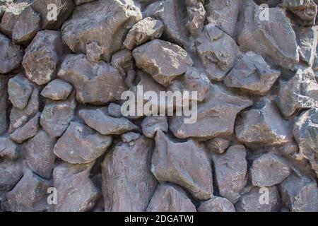 Painted black stone wall background. Black stone seamless pattern texture. Stock Photo