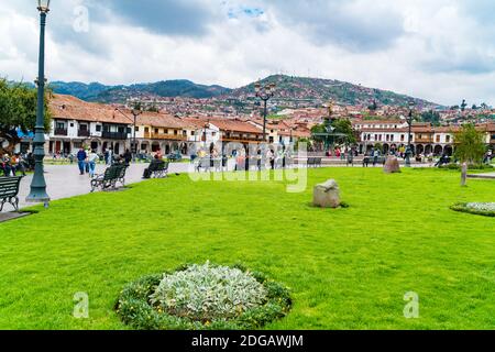 People at the Main Square Plaza de Armas with the Statue of Pachacuti and cityscape of Cusco in Peru Stock Photo