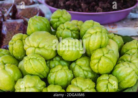 Organic Chayote fruits for sale in the market. Chayote (Sechium edule) is an edible plant that also known as christophine, cho-cho, sayote, pipinola, Stock Photo