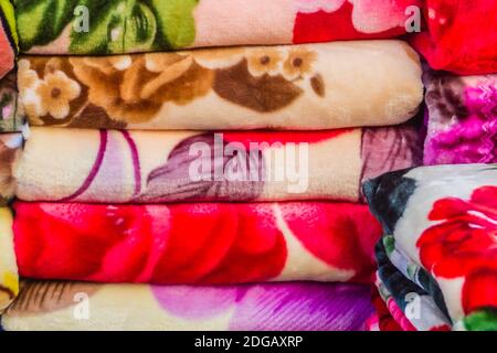 Colorful blankets for sale at the Thailand-Myanmar border market. Stock Photo