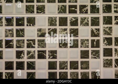 Black and white ceramic bathroom tile wall for background. Abstract square tile ornamental wall and floor pattern in bathroom. Modern pattern of mosai Stock Photo