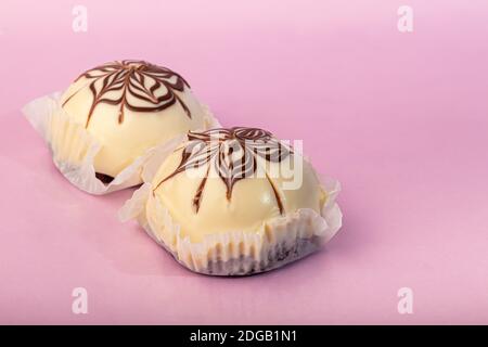 Cakes with chocolate and curd layer. Two portions. On a pink background. Birthday, holidays, sweets. Copy space. Stock Photo