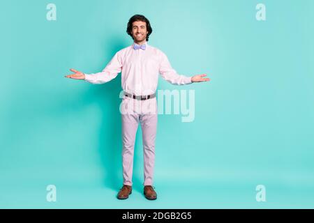 Full length photo of cheerful good mood curly wavy brunet hair fiance wear pink outfit open hands arms isolated teal color background. Stock Photo