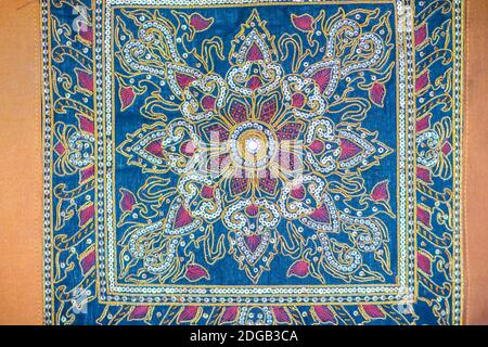 Seamless pattern on blue fabric background with white and orange elements. Classic Turkish textile ornament, mandala, kaleidoscope, vintage background Stock Photo