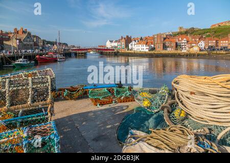 View of fishing baskets, houses and boats on the River Esk, Whitby, Yorkshire, England, United Kingdom, Europe Stock Photo