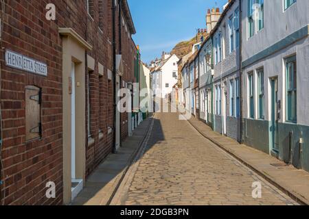 View of traditional cobbled street in historic town centre, Whitby, Yorkshire, England, United Kingdom, Europe