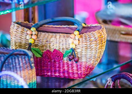 Beautiful rose flowers pattern on on handbag weaving, made from Water Hyacinth haulm. Dried water hyacinth lady handbag for sale in walking street mar Stock Photo