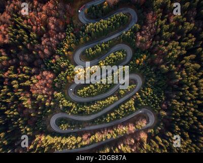 Aerial view of Curved road in the mountains with trucks and cars. Autumn season. Cheia,Brasov,Romania. Stock Photo