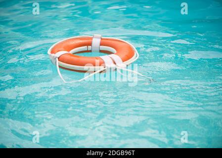 Life buoy. Lifebuoy in water. Life ring floating in a sea, life preserver. Rescue ring. Rescuering, Safety ring in blue water. Stock Photo