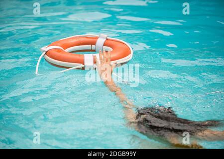 Life buoy, concept of help, rescue. Lifebuoy in water. Life ring floating in a sea, life preserver. Rescue ring. Rescuering, Safety ring in blue water Stock Photo