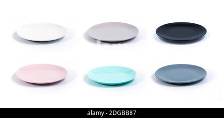 Set of six colorful empty plates isolated on white background side view, selective focus. White, Grey, Black, Pink, Turquoise and Navy Blue empty plat Stock Photo