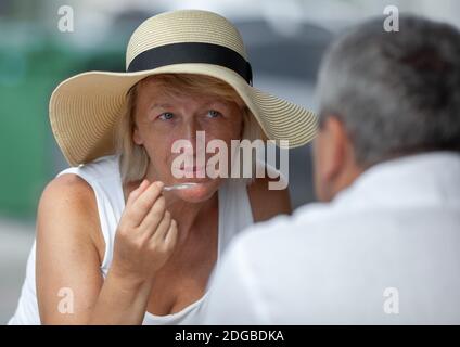 Mature woman in outside cafe Stock Photo