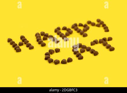 text from animal feed. text happy cat. eat for animals. yellow background. High quality photo Stock Photo