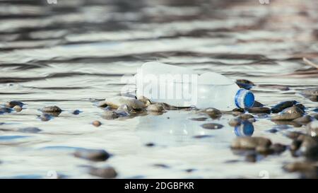 Environmental pollution: plastic bottle on the beach Stock Photo