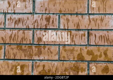 Brown old dirty brick wall consists of rectangular blocks background base Stock Photo