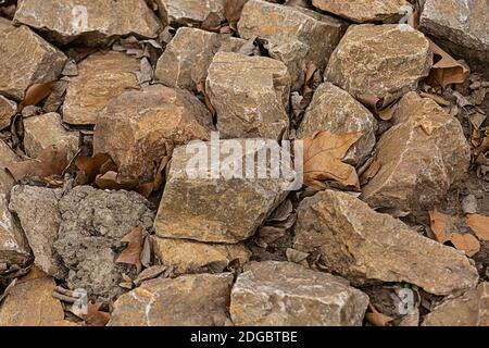 Stone beige, brown pattern of many cobblestones weathered and solid, the background of the quarry Stock Photo