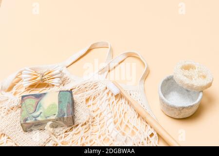 Zero waste bathroom accessories on camel color background. Natural eco bamboo product. Plastic free beauty essentials. Stock Photo