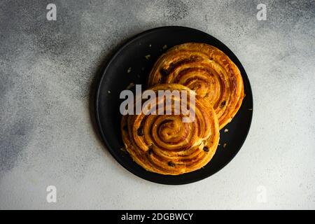 Overhead view of a two pain aux raisins on a plate Stock Photo