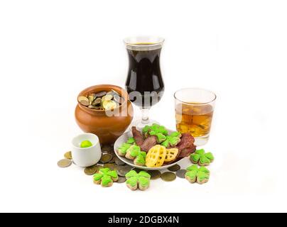 Celebration of St. Patrick's Day with a dark beer whiskey appetizers and a pot of scattered coins an Stock Photo