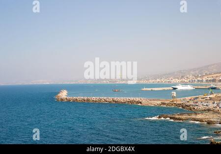 Beautiful amazing views from the cliff on the blue azure sea and the port on the island of Crete in Stock Photo