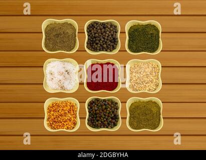 Collection of spices in ceramic bowls on a wooden background fragrant paprika paprika fennel and cor Stock Photo