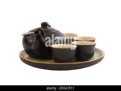 Black clay pot on a deep tray plate with small cups Stock Photo