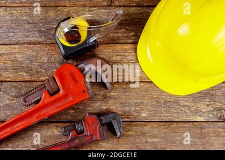 Yellow hard hat and leather work gloves and wrench construction Stock Photo