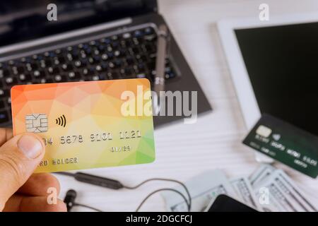 Notebook with pen, tablet pc with money and credit card, phone, on wooden background Stock Photo