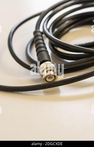 Black coaxial cable for signal transmission to set up cable television Stock Photo