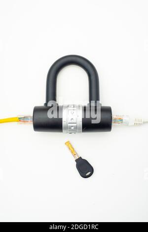 Two computer network cables going through a lock with a key Stock Photo