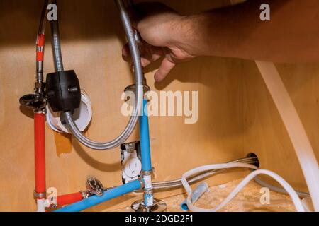 Repair in plumber installing assemble new mixer tap hands worker close up. Stock Photo