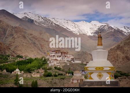 Likir monastery set amongst irrigated fields with mountain peaks beyond. Likir, Ladakh, Jammu and Kashmir, India Stock Photo