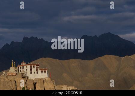 Lamayuru monastery perched on a hilltop overlooking Lamayouro town, Leh District, Ladakh, Jammu and Kashmir, northern India. Late afternoon sunlight. Himalayan peaks beyond. Stock Photo