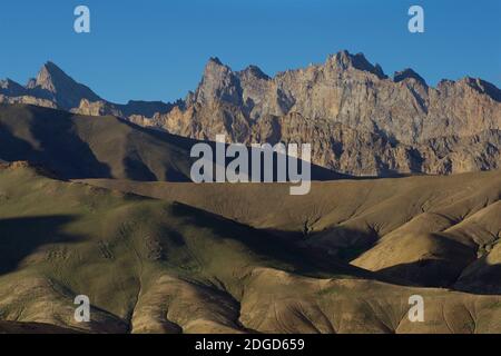 Morning sunlight illuminates the mountain peaks beside the Leh to Srinagar highway near Lamayouro, Ladakh, Jammu and Kashmir, India Stock Photo