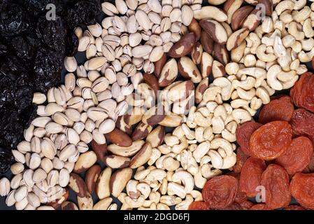 Diagonal pattern of different varieties of nuts and dried fruits Stock Photo